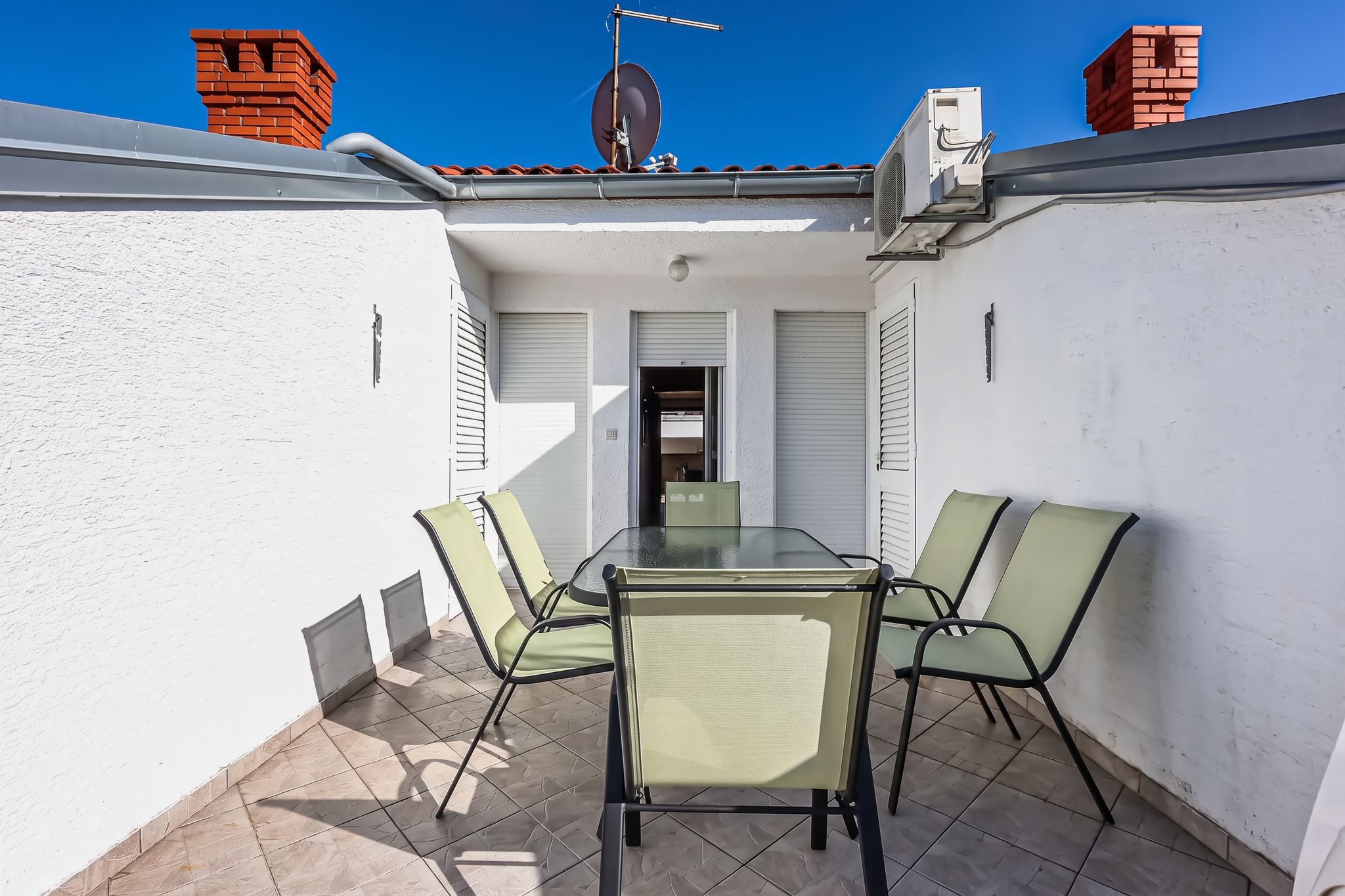 The apartment door onto the roof balcony, with the chimneys behind