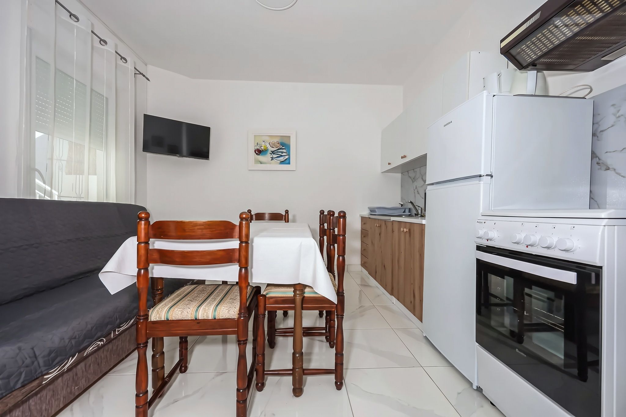 The same room from the other end, with the sofa-bed and the cooker beyond
