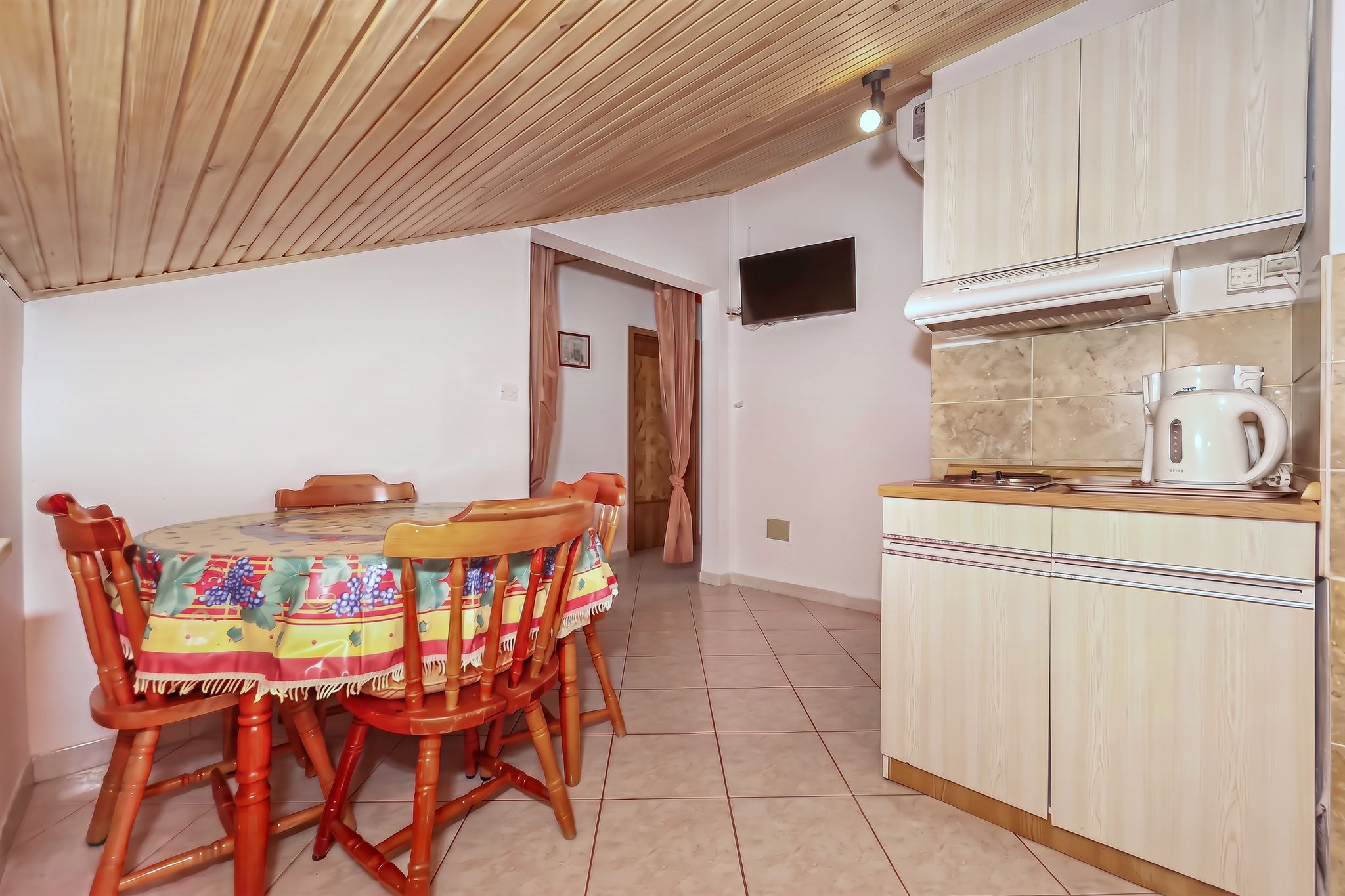 The same room from the other end, with the kitchenette and the hallway beyond