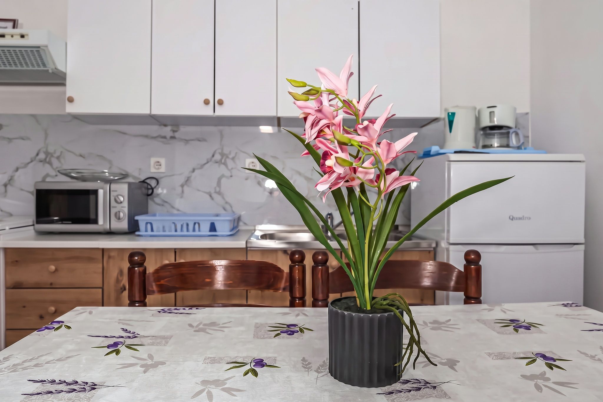 The kitchen seen across the dining table